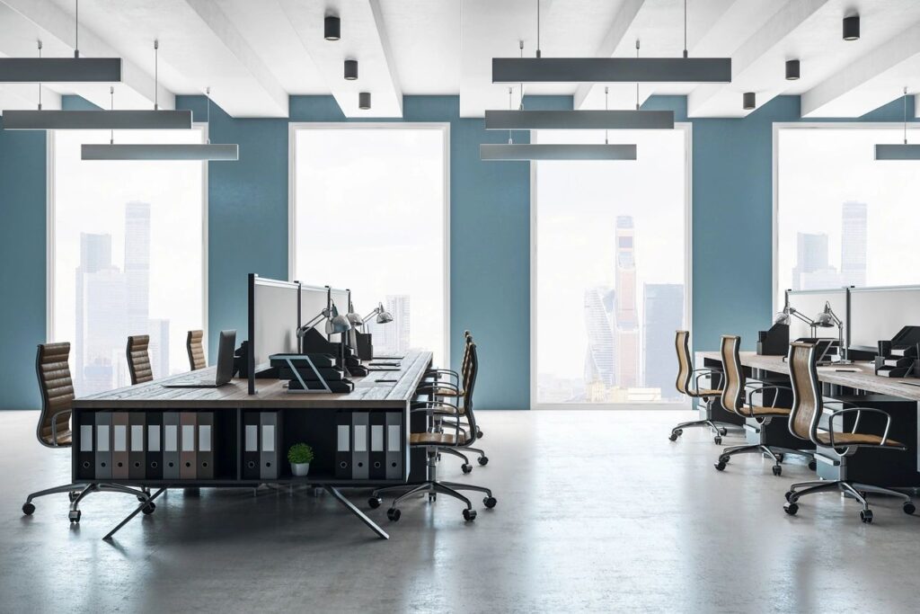 A large open office space with many desks and chairs.