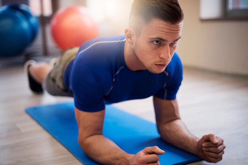 A man is doing an exercise on the floor.